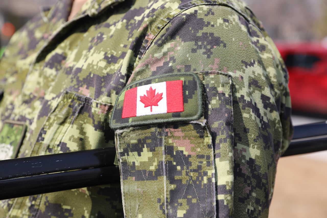 A Canadian flag badge is displayed on the uniform of a Canadian Armed Forces soldier. 