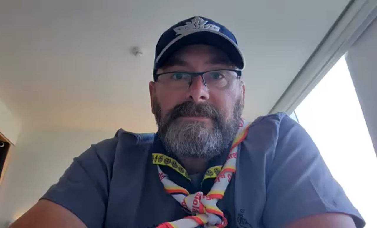 A man in a scout leader uniform on Zoom
