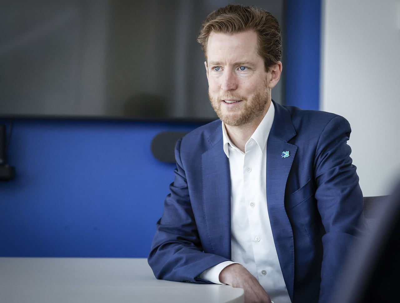 Portrait shot of WestJet CEO Alexis von Hoensbroech at a meeting hall. 