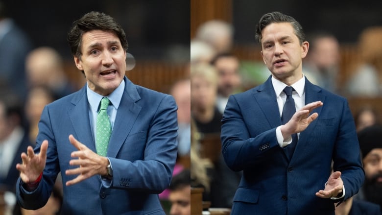 Two men standing and speaking to a room full of people.