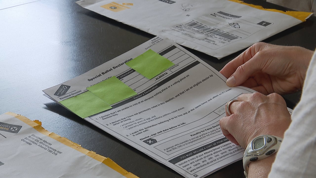 A woman flipping through forms.