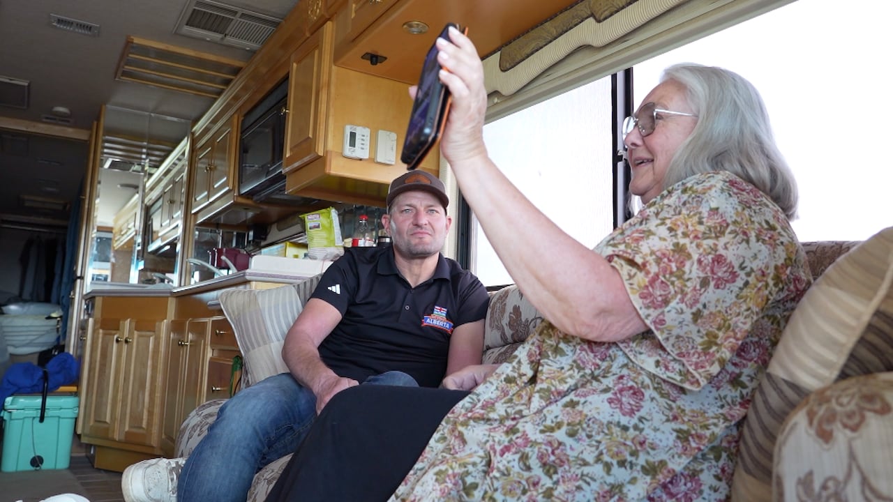 Two people sit on a bus.