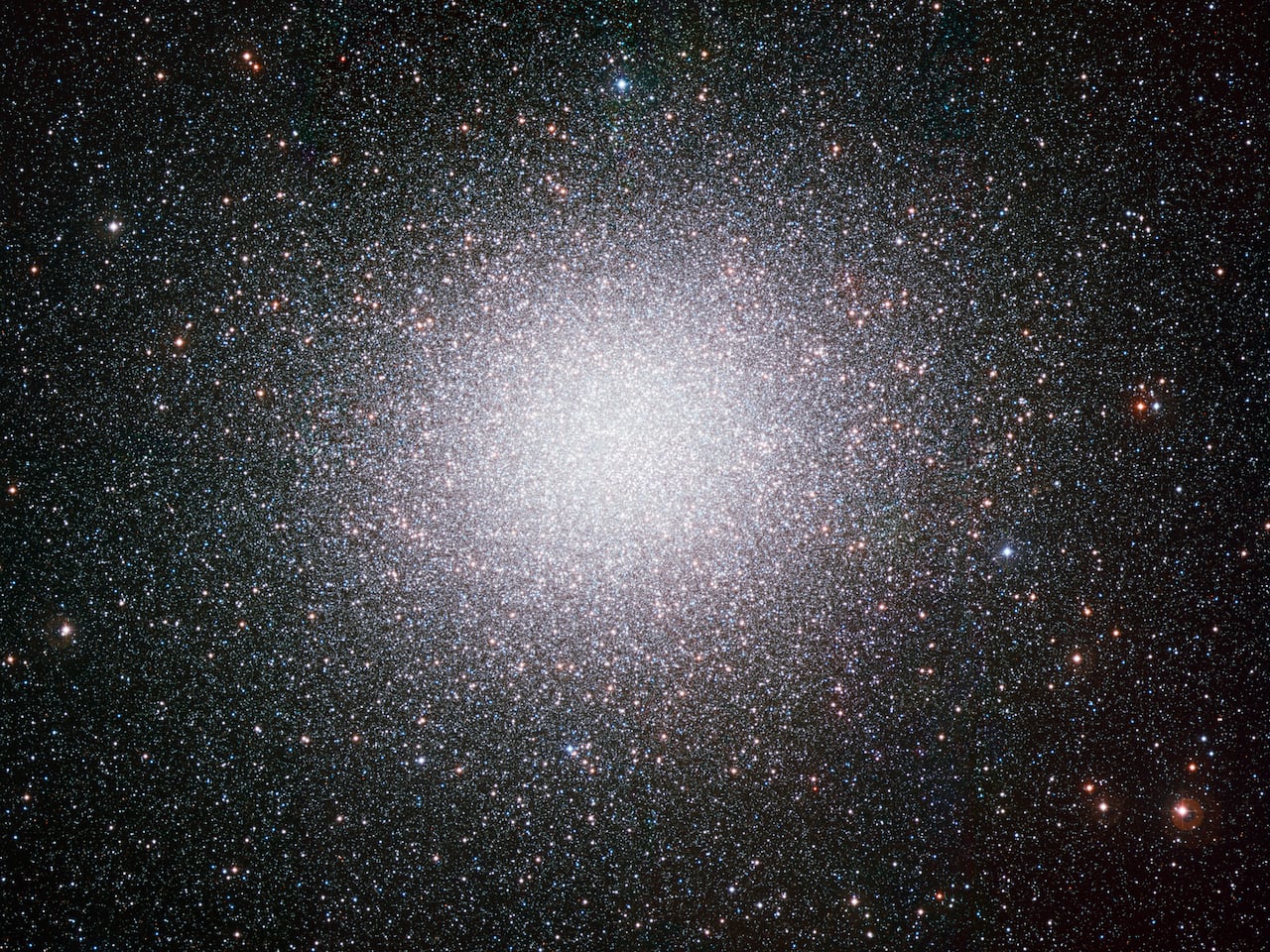 A round cluster of stars hangs in space.