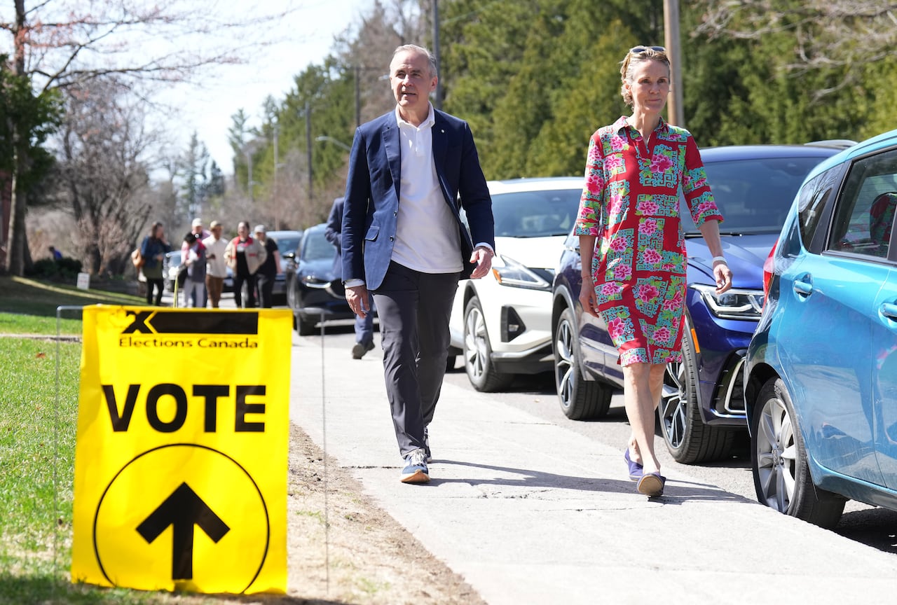 Carney and his wife are shown walking outside a poling centre.