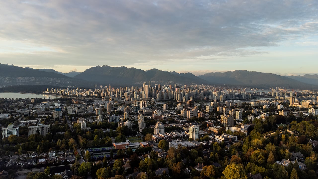 A downtown skyline is visible in the distance from the air.