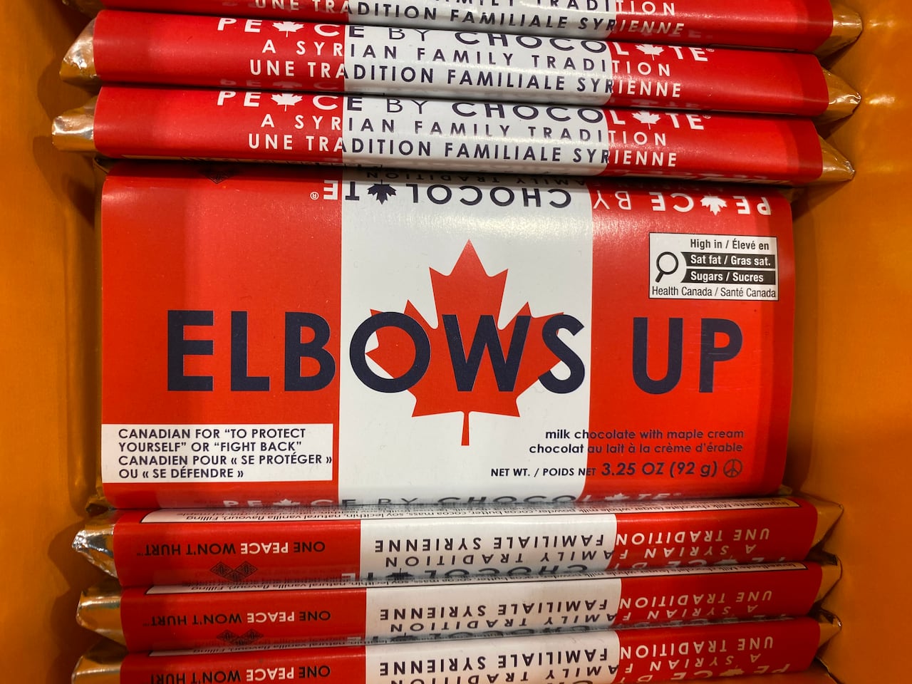 A chocolate bar with a Canadian flag design that reads "elbows up"