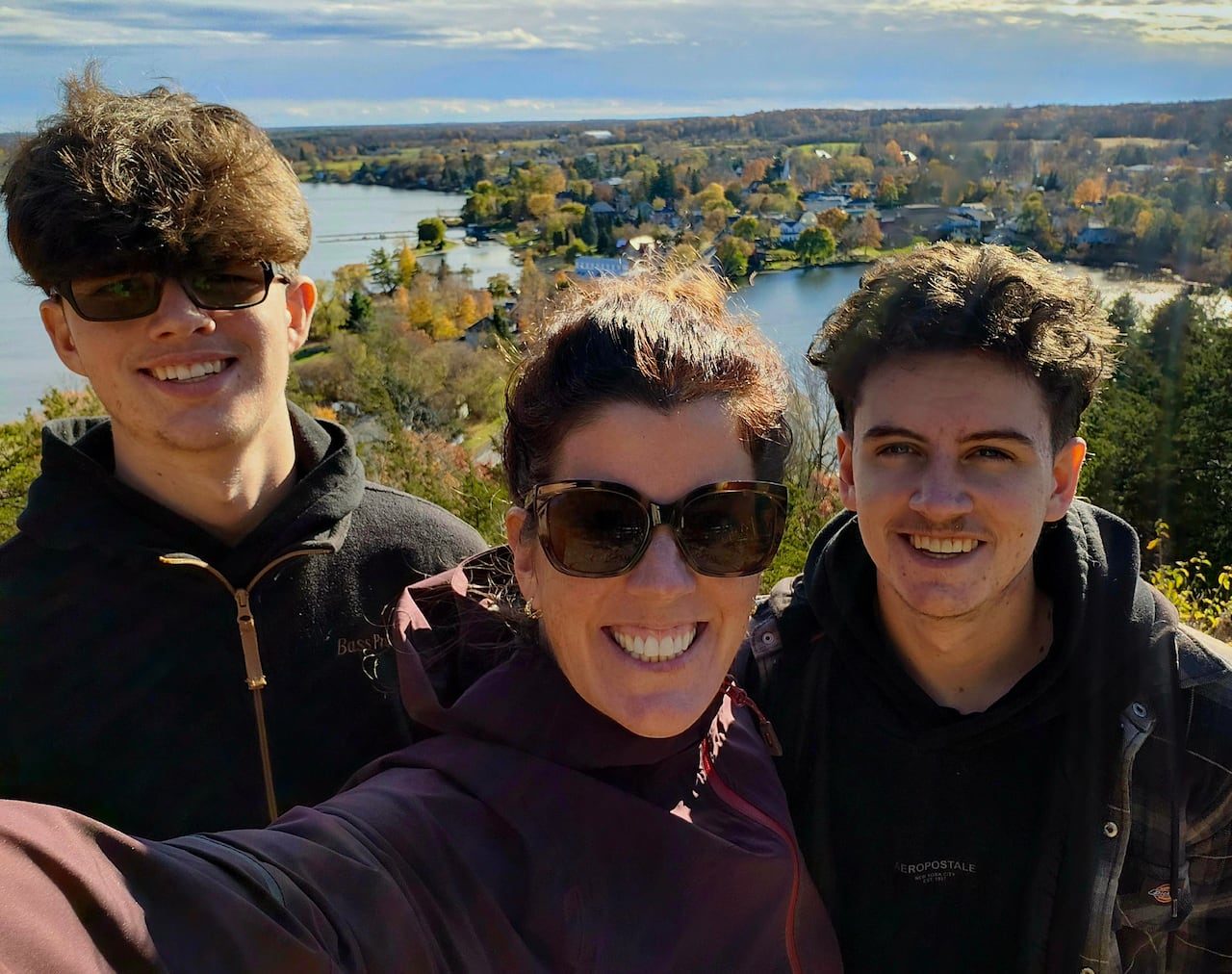 A woman poses with her two sons.