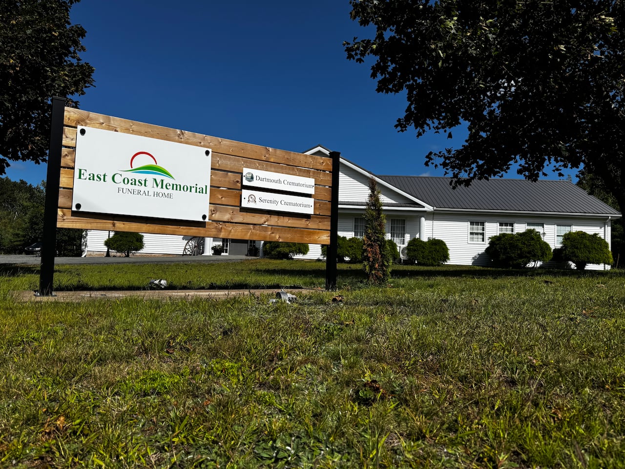 A white building is pictured with a sign in front that says East Coast Memorial.