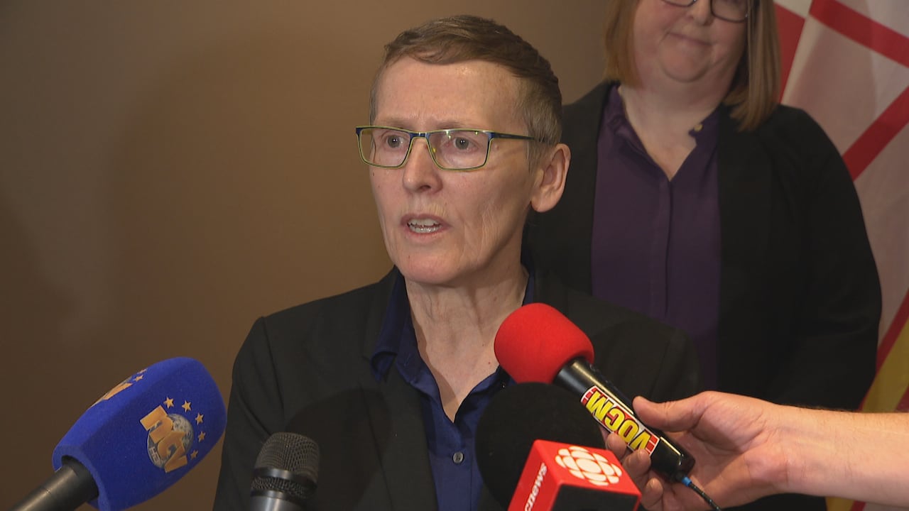Woman with short hair with microphones near her.