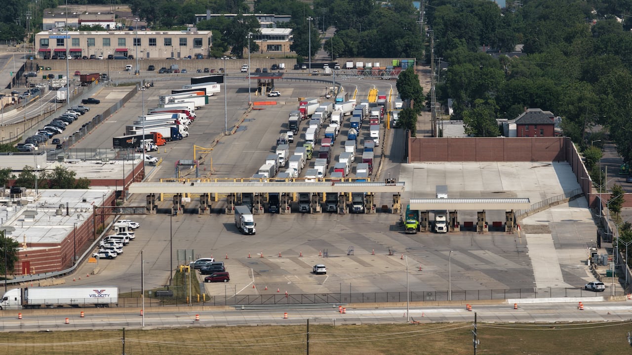 Trucks line-up a border booths at the Ambassador Bridge days after the Gordie Howe bridge opened to traffic in July 2026.