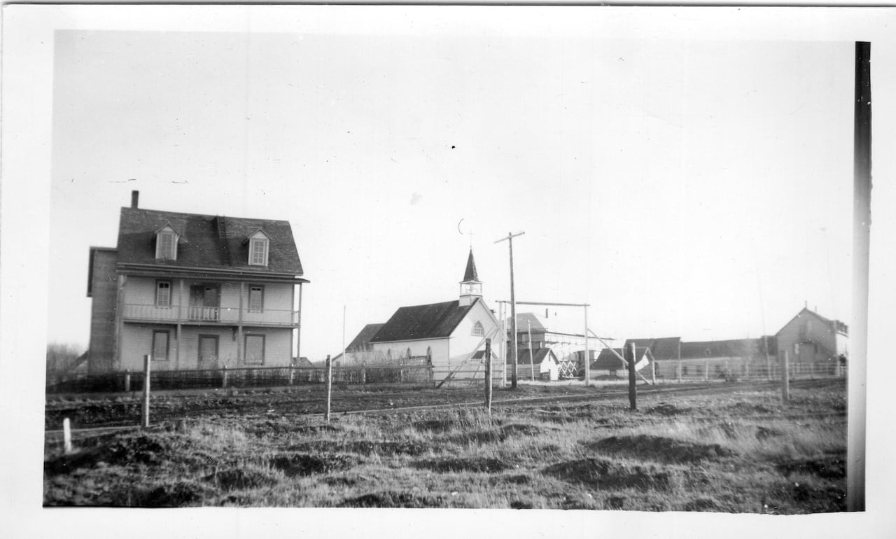 A building and church in black and white.