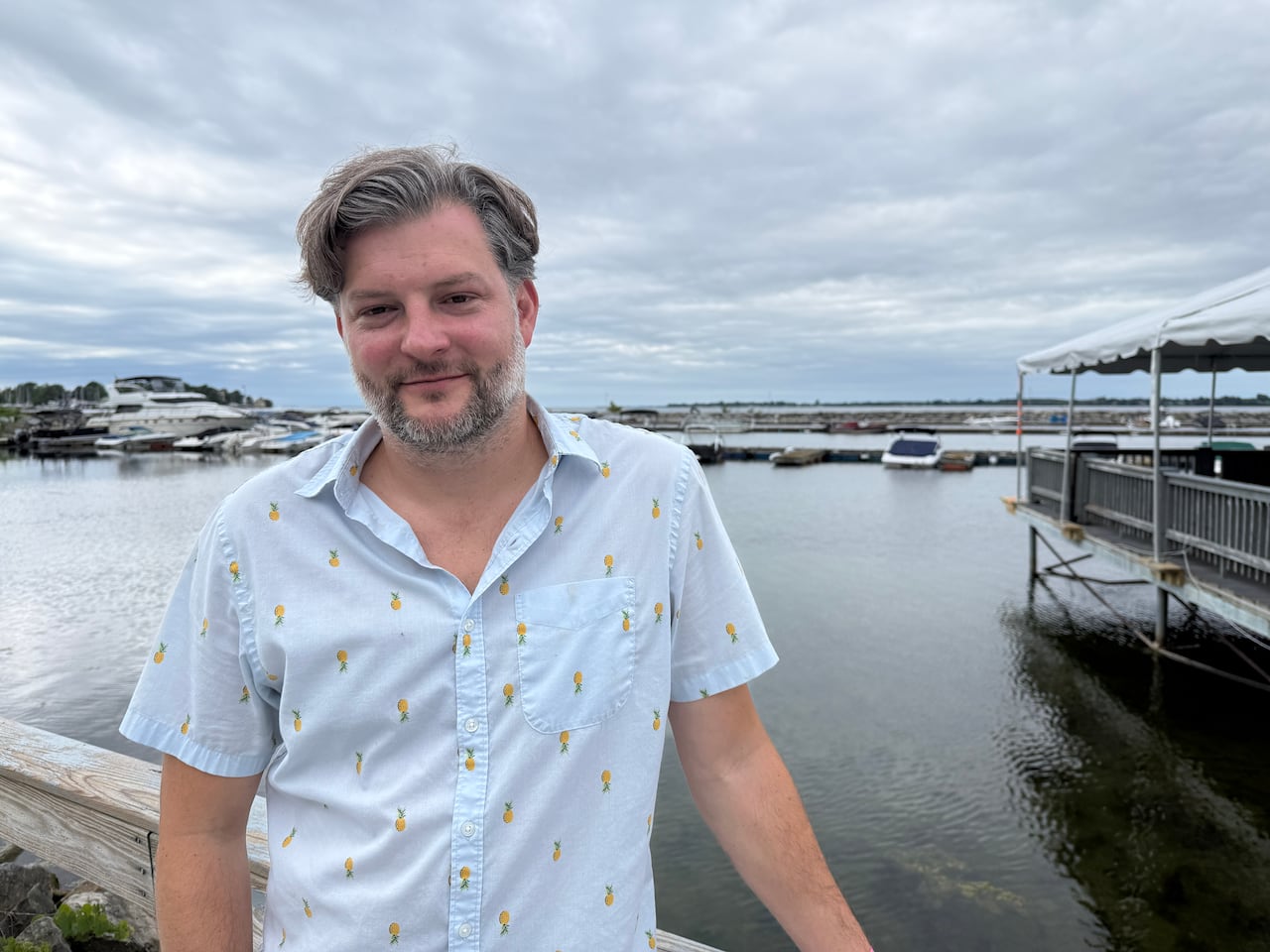 A man stands on a marina