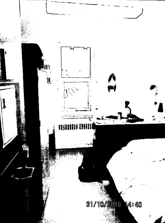 black and white interior of a college dorm room