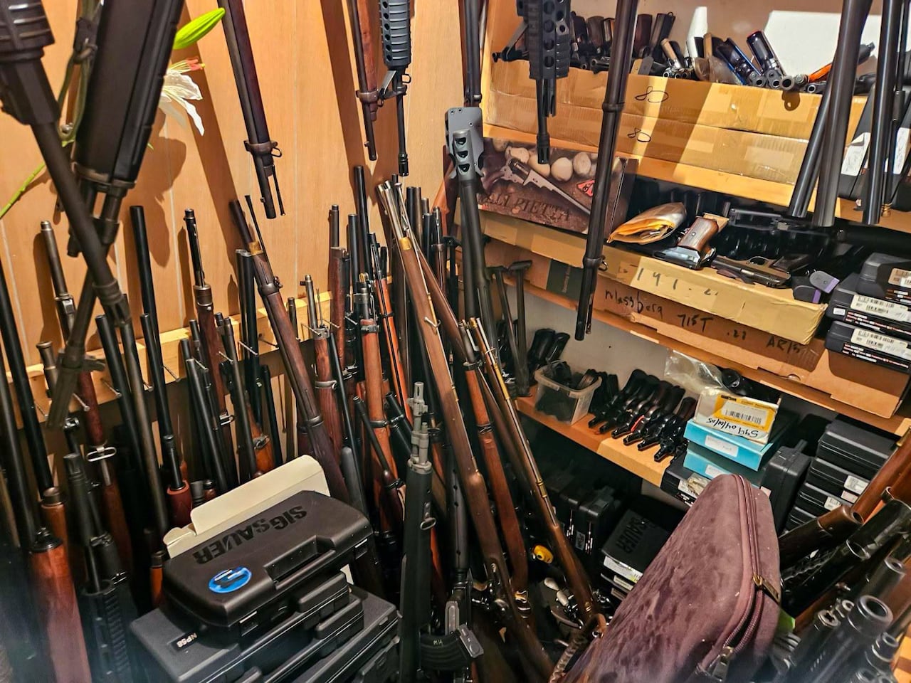 Dozens of long guns are shown.
