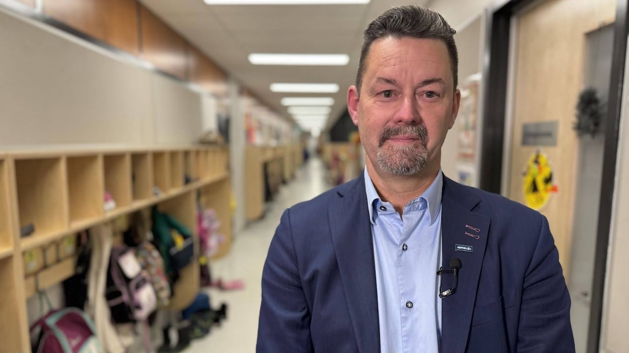 A man stands in a school.