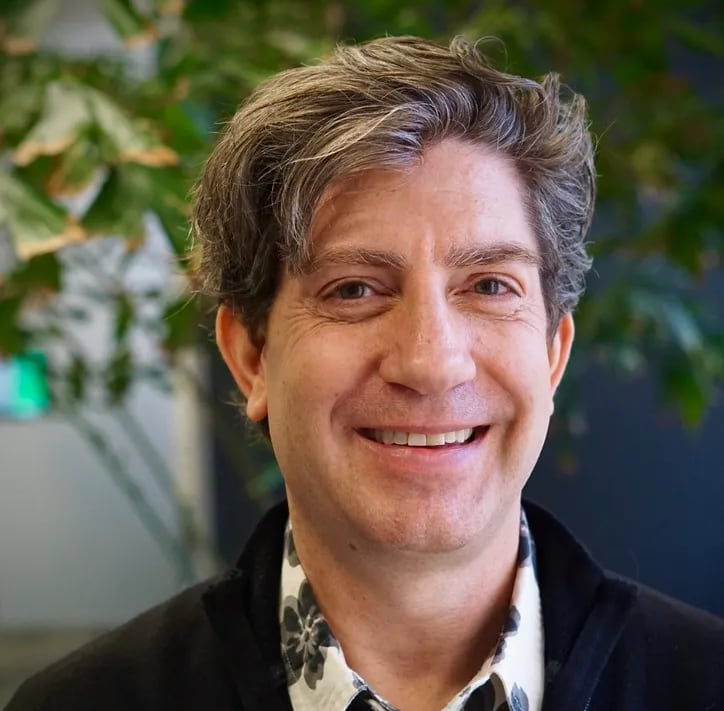 A smiling man with floppy hair.