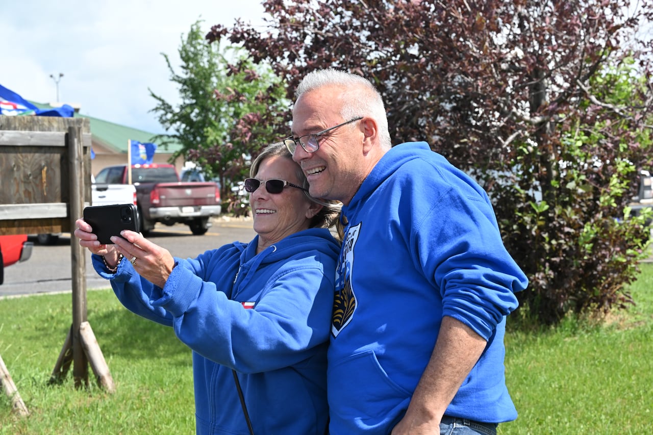 Cory Morgan poses for a selfie with a supporter during a rally supporting Alberta independence in Taber, Alta., on Sunday, June 28, 2026.