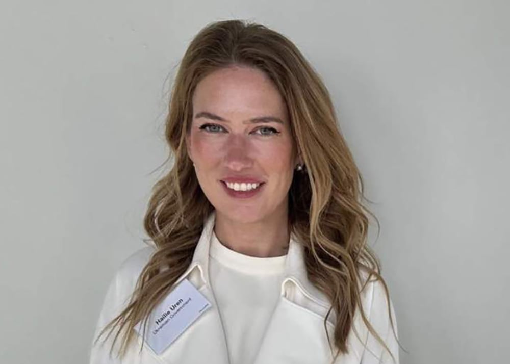 close  up shot of woman with long blond hair in white coat