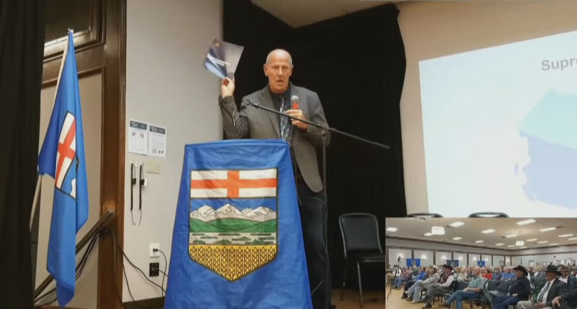 Alberta Prosperity Project leader Mitch Sylvestre holds up a copy of the 'Foundation of Freedom' document at an event in Airdrie, Thursday.