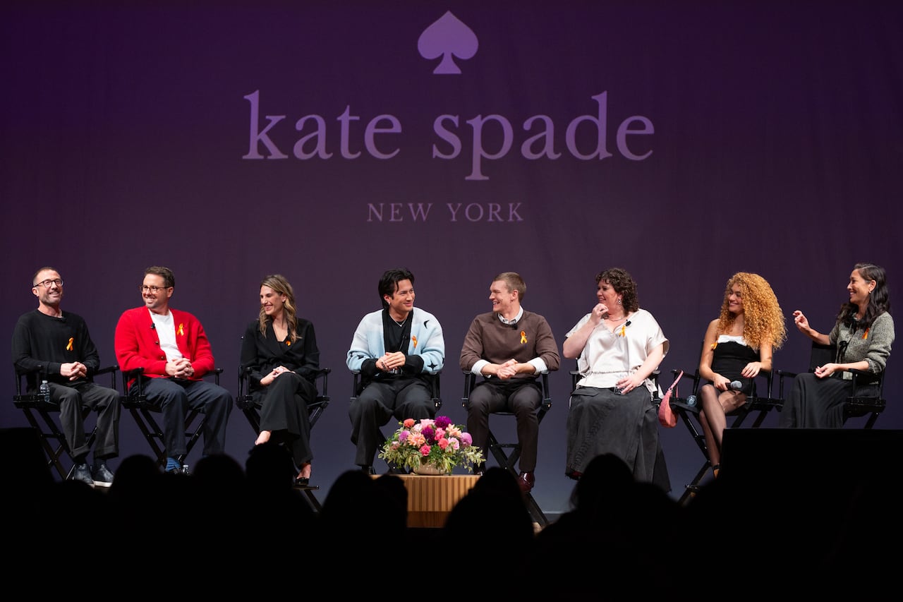 A group of people on stage in a panel discussion