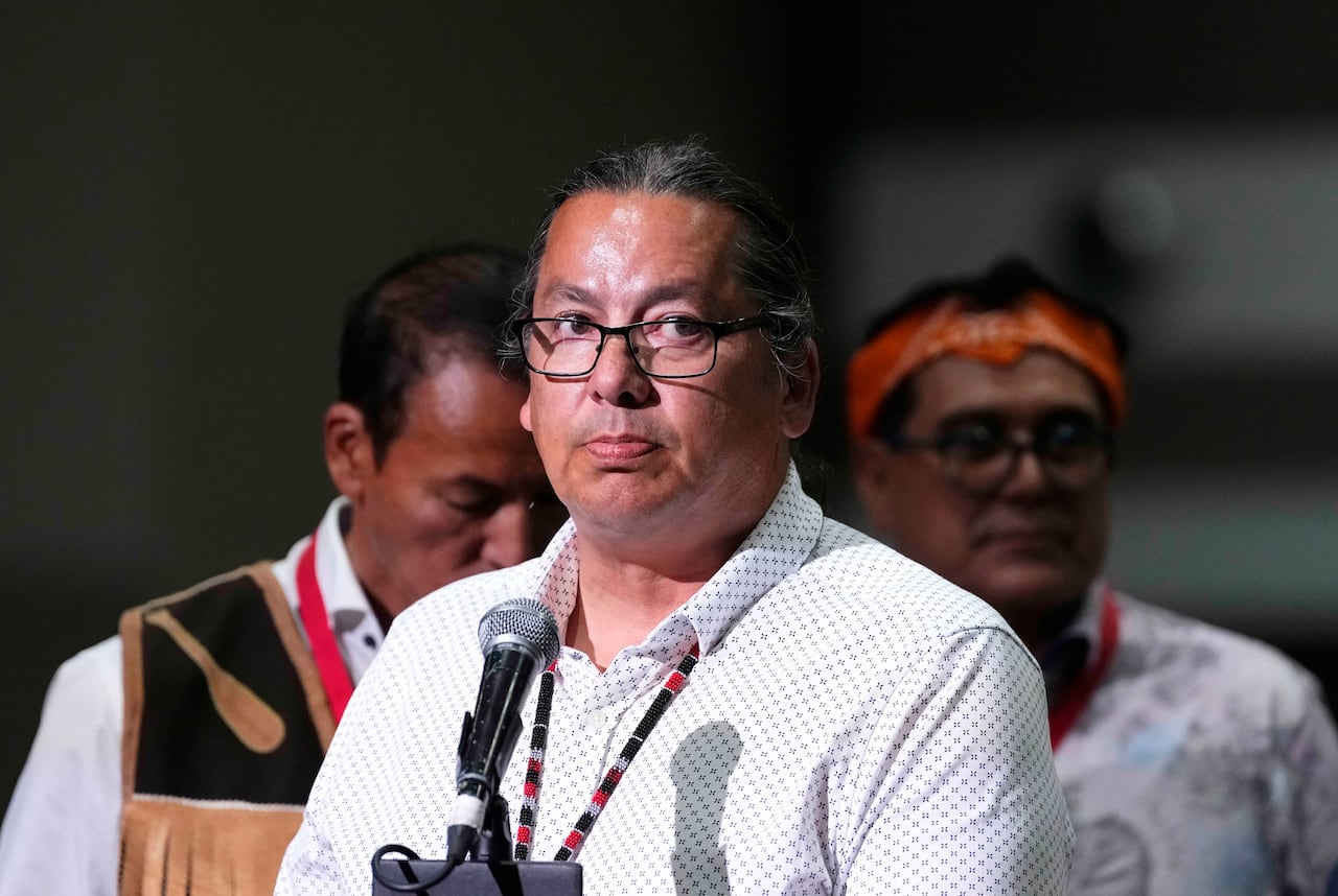 A man stands at a microphone