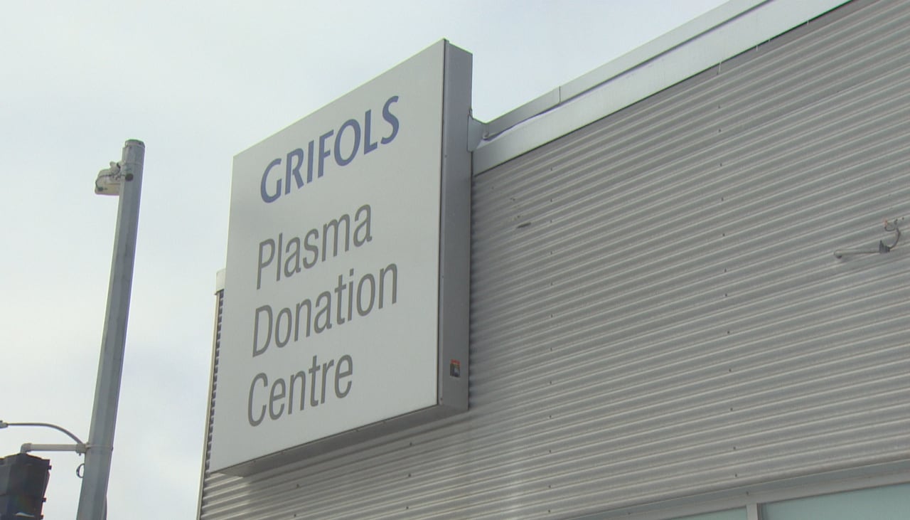 The exterior of a building with a sign reading "Grifols plasma donation centre."