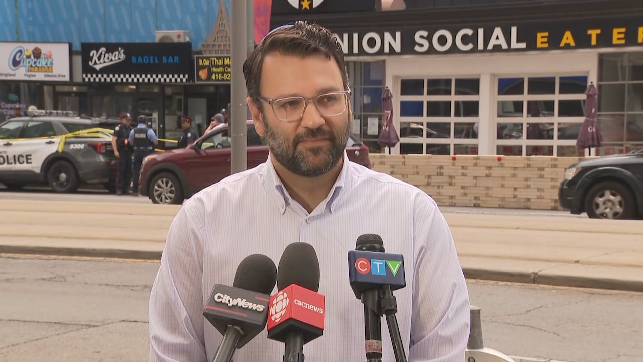 Man speaking in front of microphones
