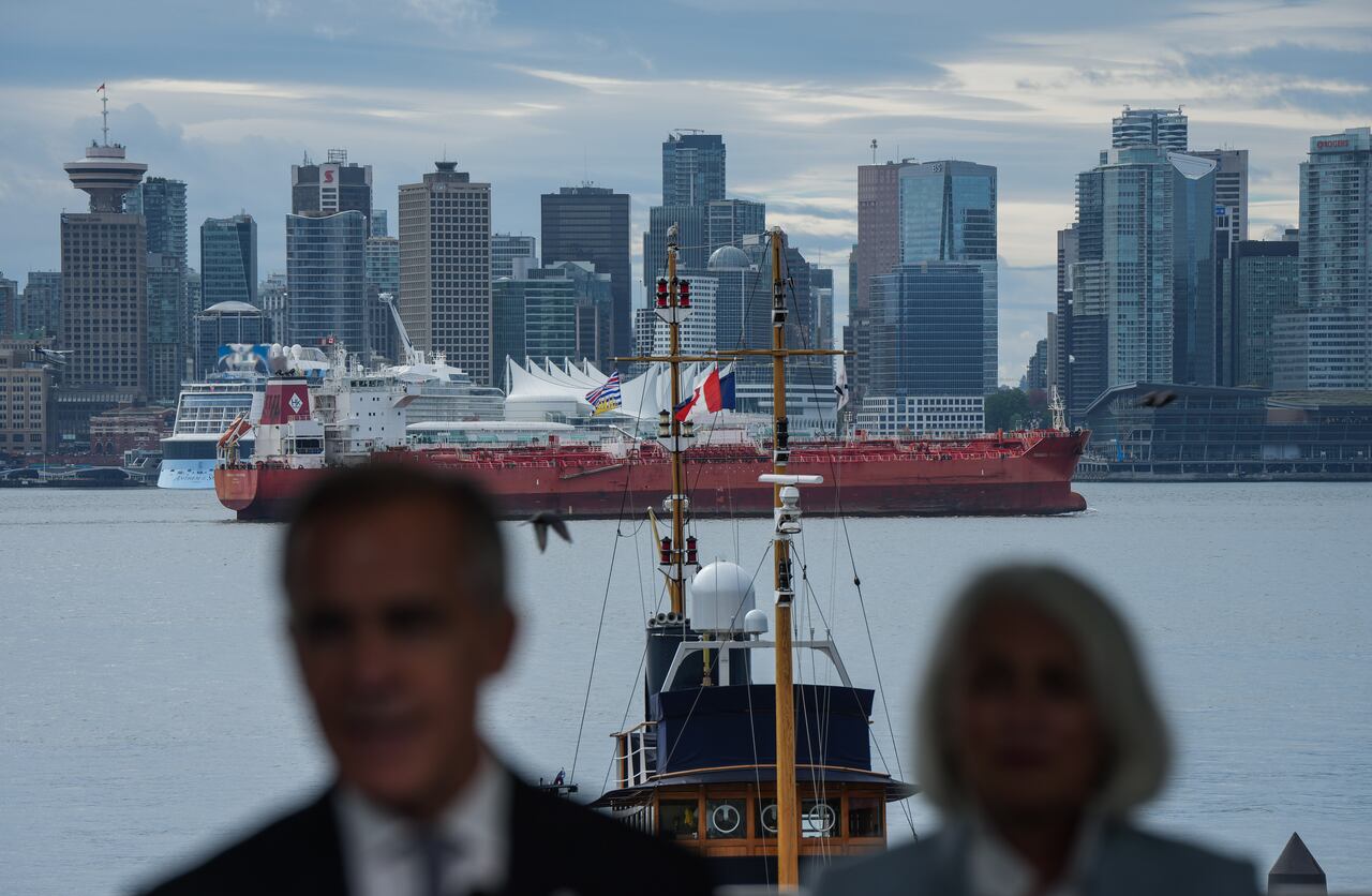 The Panagia Thalassini oil tanker passes on the harbour behind Prime Minister Mark Carney and Minister of Fisheries Joanne Thompson as he speaks during an announcement about funding for oceans protection, on Tuesday, Sept. 29, 2026.