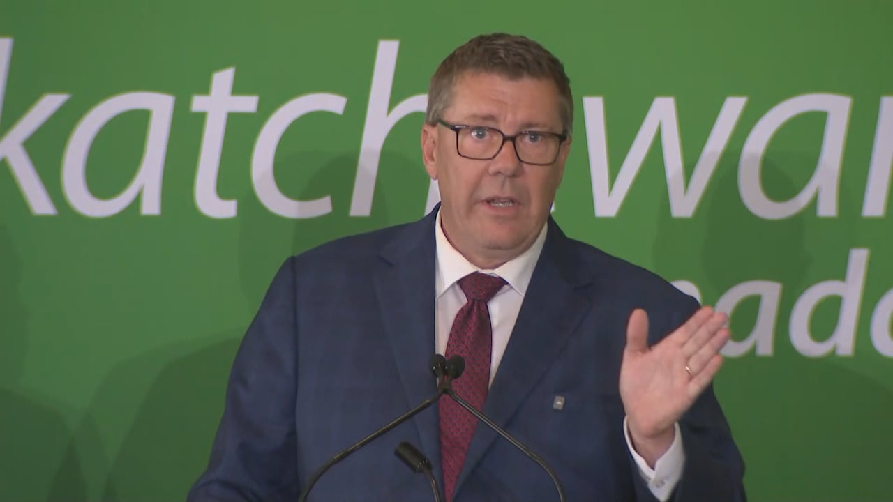 a man in a suit gestures while he speaks