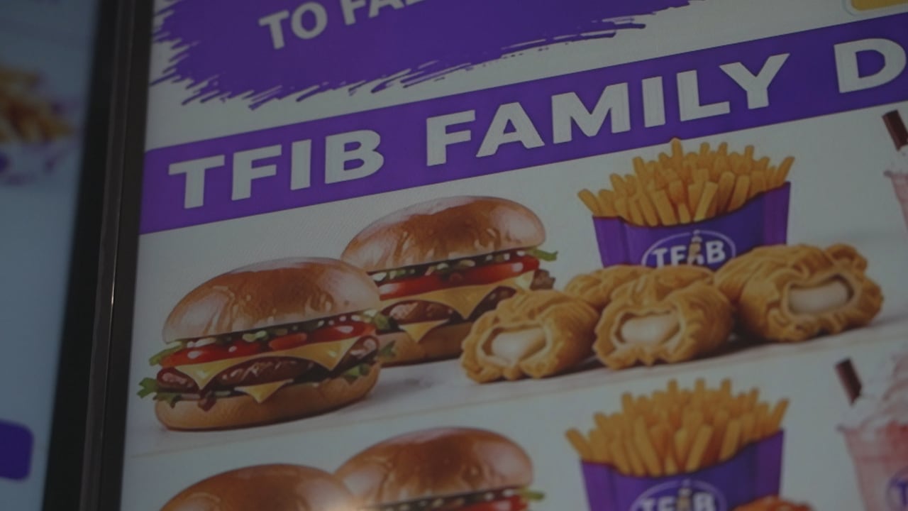images of burgers, chicken nuggets and fries in purple packaging on a menu board