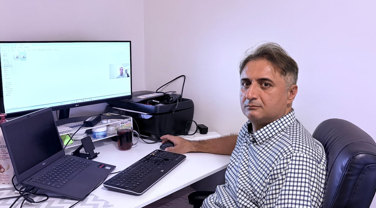 A man sitting in front of desktop.