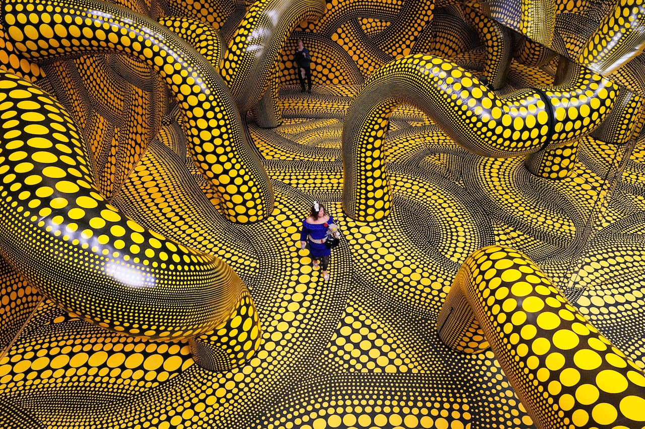 A picture of someone walking through an art installation covered in polkadots