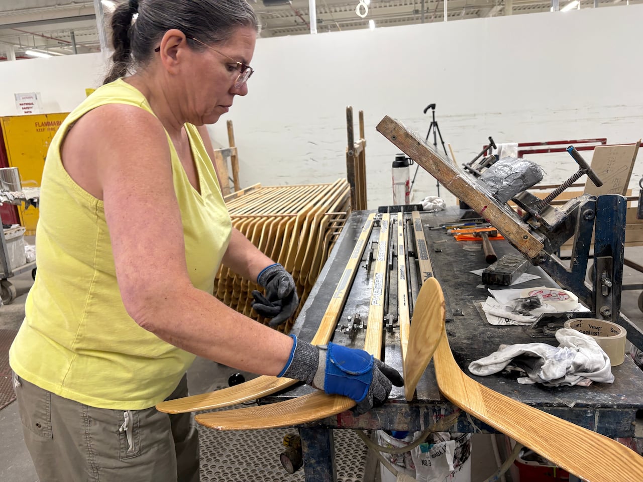 A worker makes wooden hockey sticks at the Roustan Hockey factory, which is the last major manufacturer of hockey sticks in Canada on Aug. 27, 2025 in Brantford, Ontario.