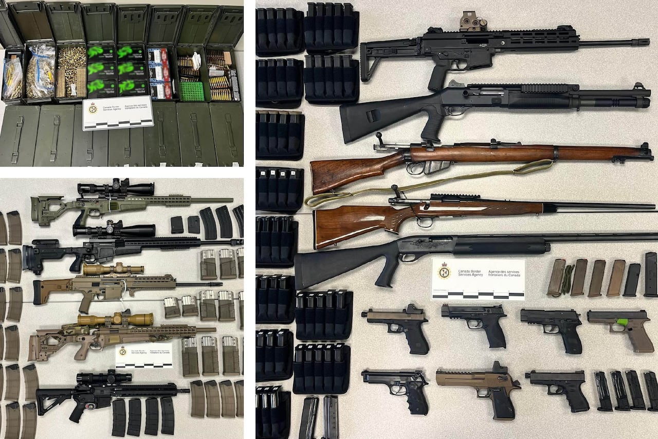 Rifles, shotguns and pistols are displayed on a table, along with magazines and bullets.