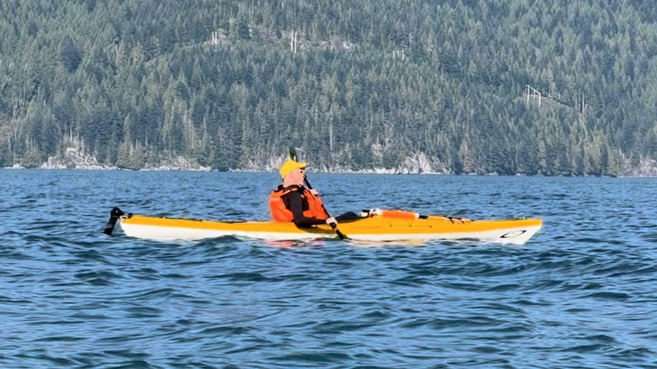A man kayaking in the ocean