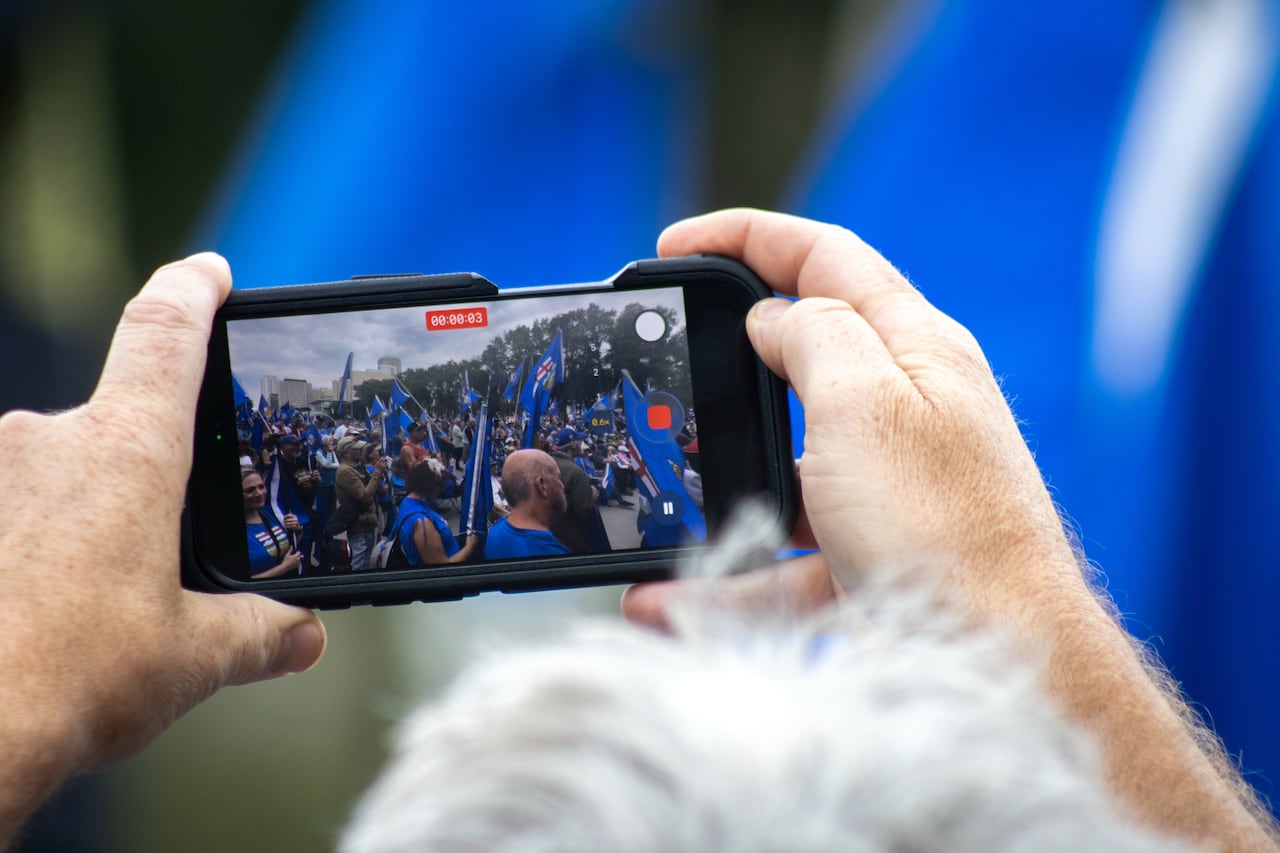 close up image of two hands holding a cellphone