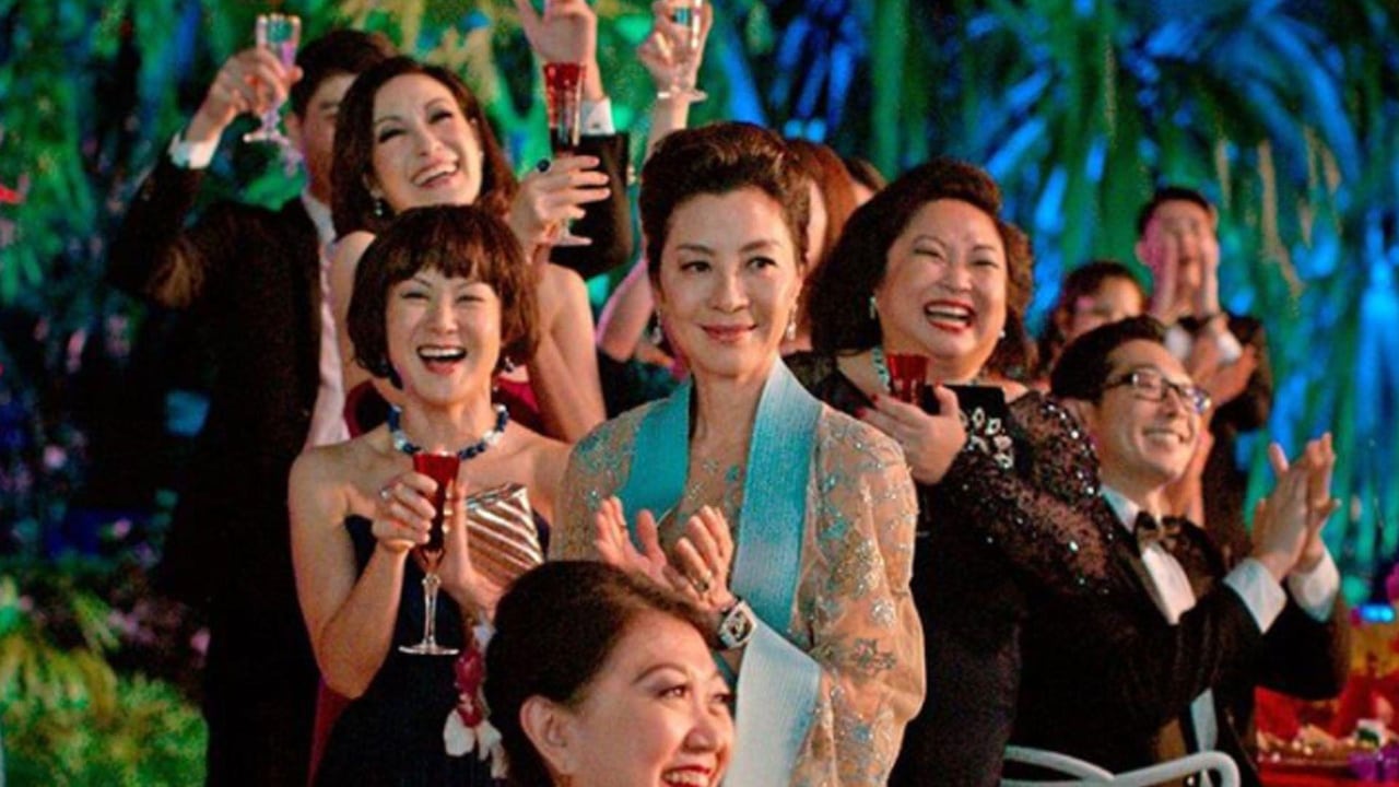 Woman stands in crowd of fancy guests.