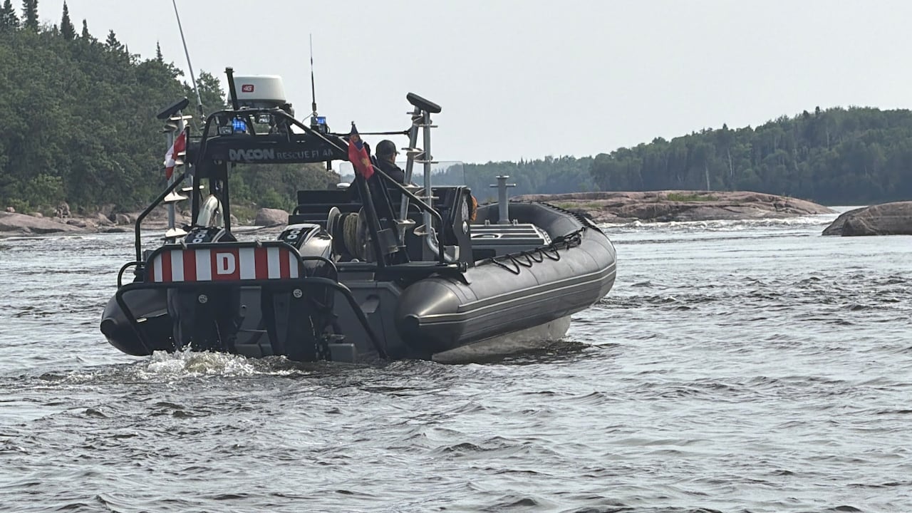A Zodiac rescue boat searched on a lake