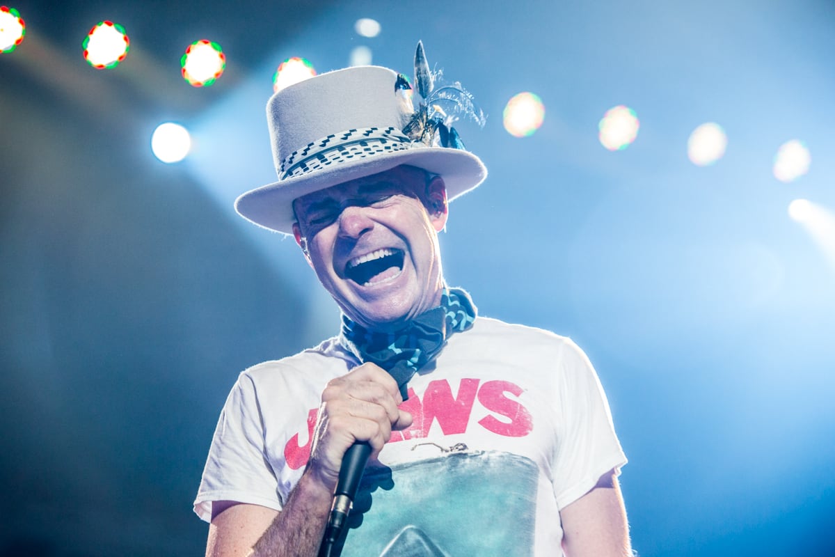 A man in a top hat sings.