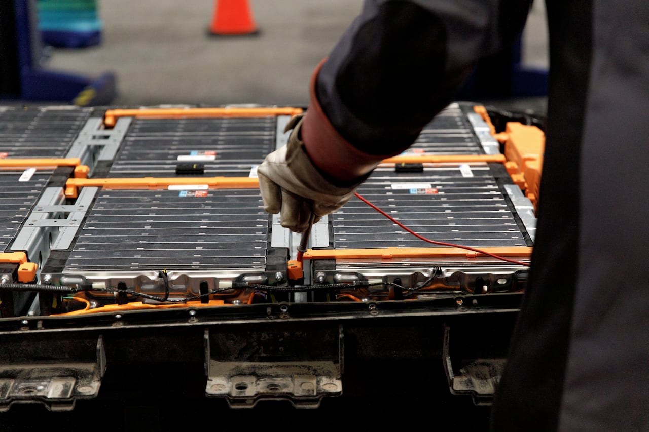 An electric vehicle battery is displayed open during a demonstration at the EV & Charging Expo in Toronto on April 8, 2026.