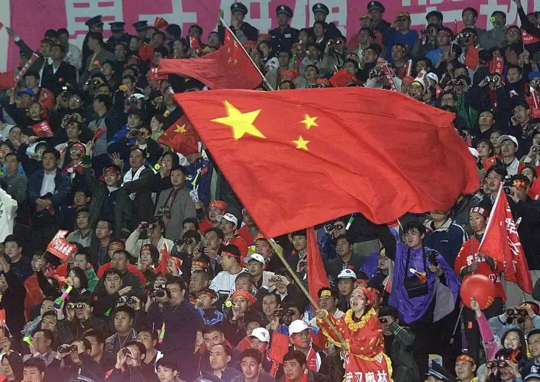 2001年10月7日，沈阳五里河体育场，中国队对阵阿曼队的比赛中，球迷们在看台上挥舞国旗。