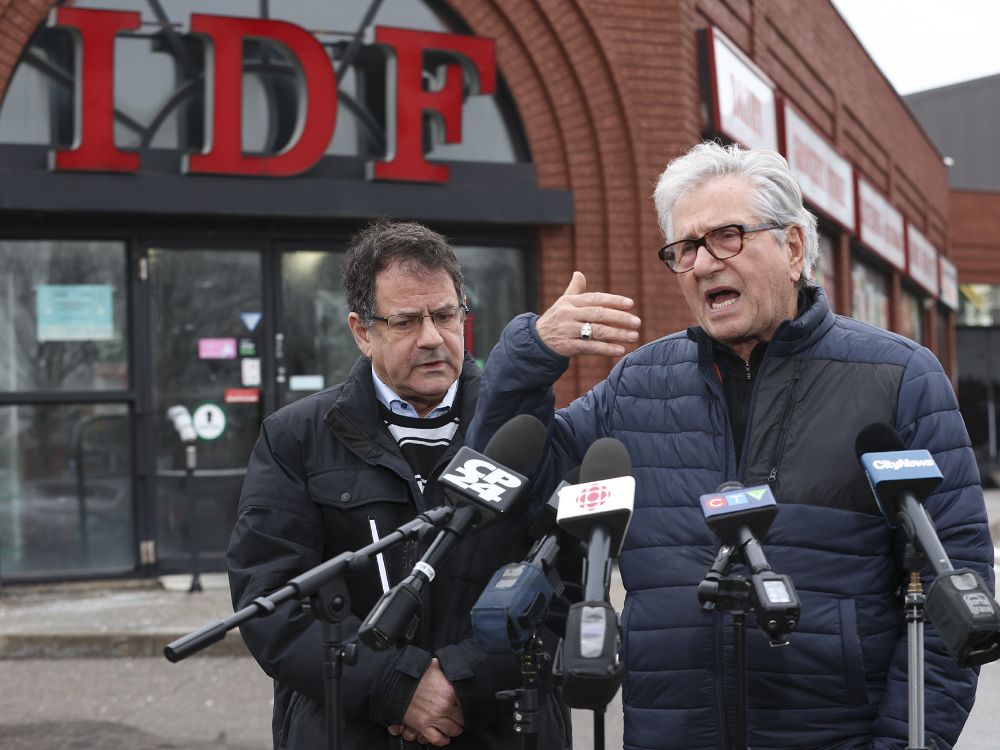Deputy Toronto mayor Mike Colle (R) and councillor James Pasternak stand outside of International Deli Foods
