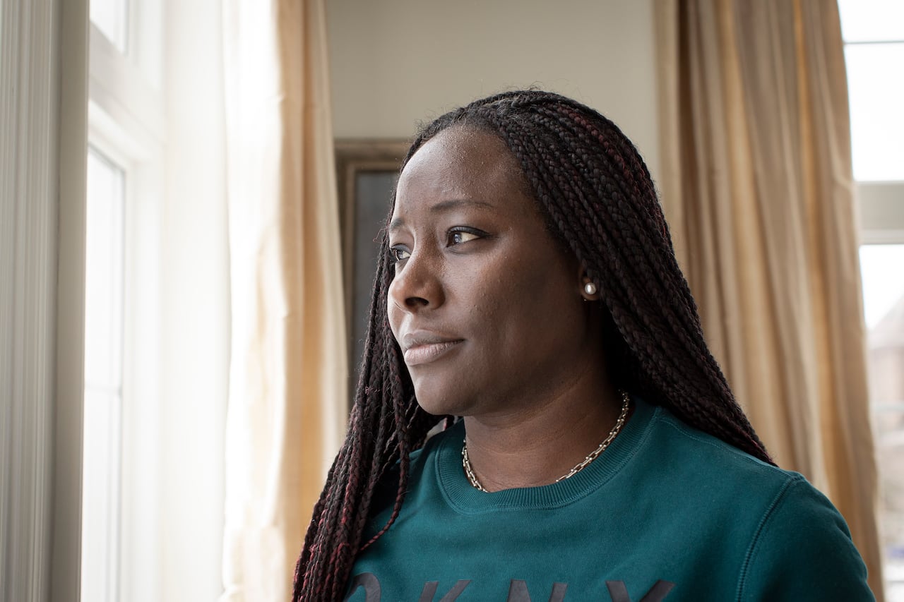 Charline Grant, CEO of Parents of Black Children group, stands looking out a window.