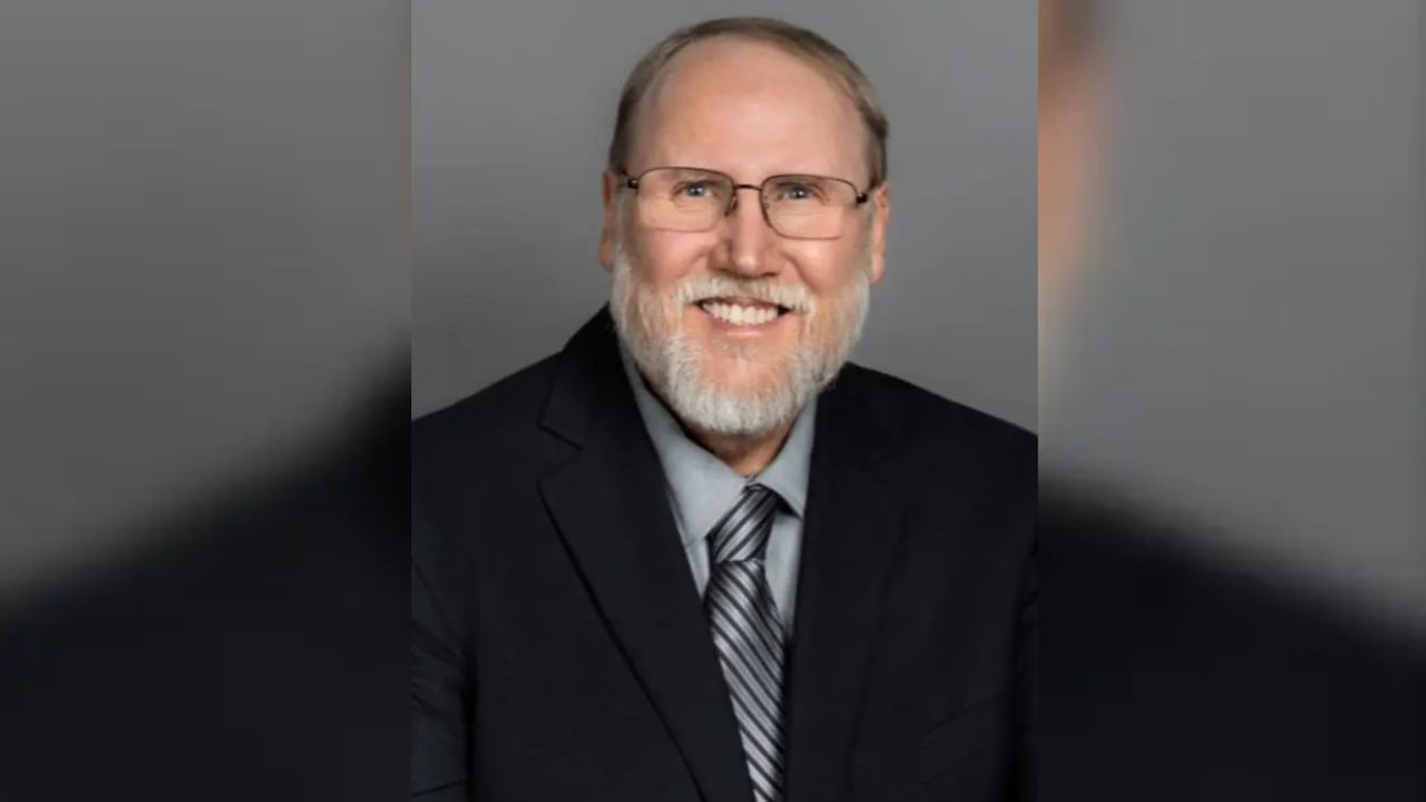 Headshot of a man in a suit