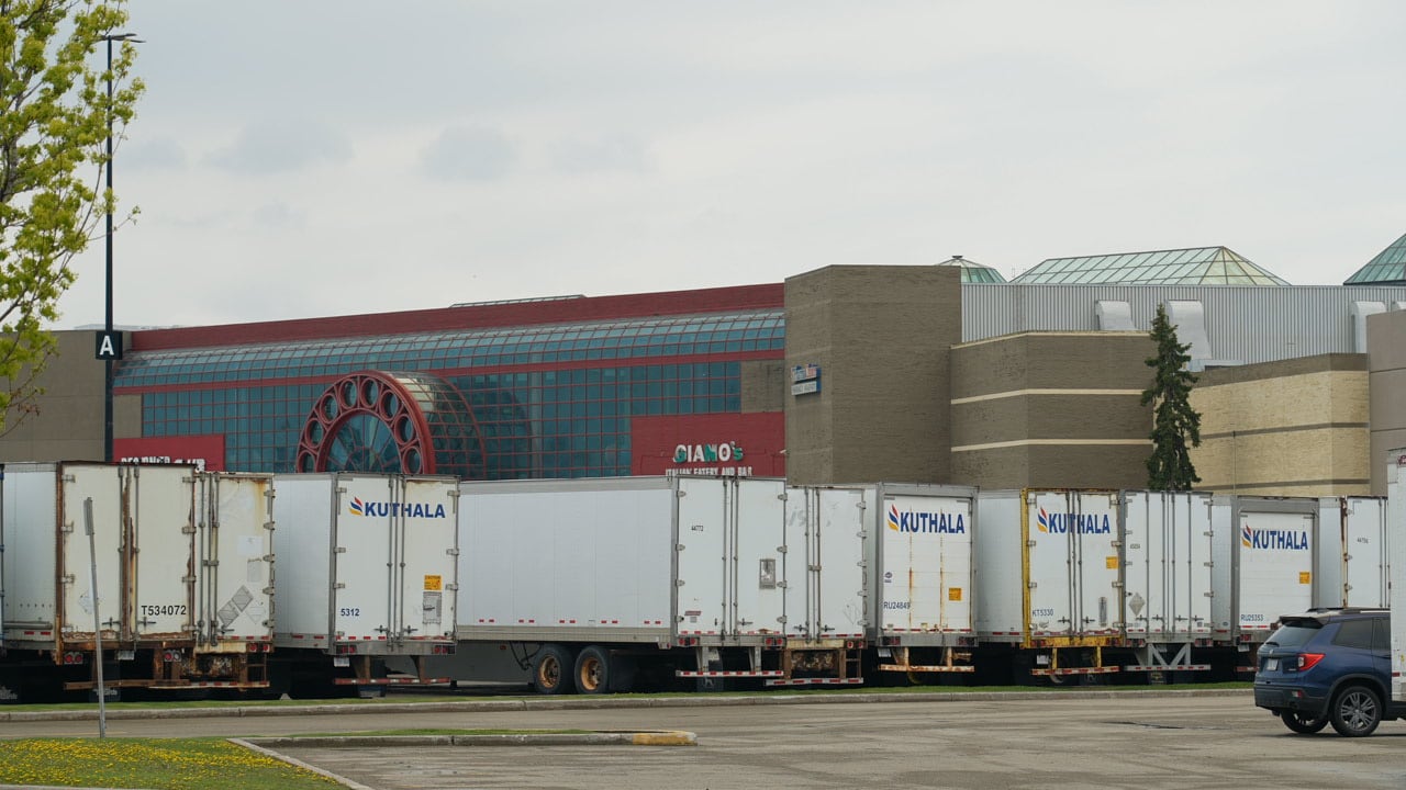 Tractor trailers lined up in a parking lots