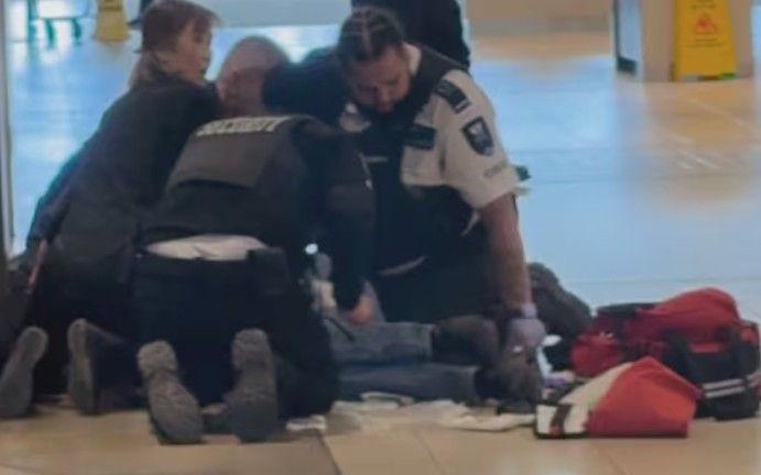 A security guard receives medical attention after being shot inside Fairview Mall in Toronto on Tuesday, April 22, 2026. @ResistWire/SCREENGRAB