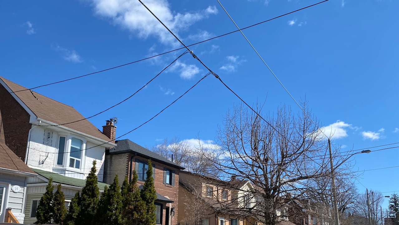 Overhead cables connecting to houses on a residential street