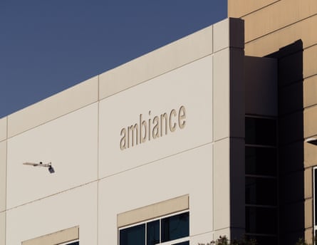 A white and gray concrete building facade with the word “ambiance” engraved