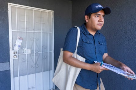 a man holds a clipboard while walking away from a door