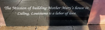 An inscription on a piece of stone says ‘This Mission of building Mother Mary’s house in Luling, Louisiana, is a labor of love’ with a piece of black tape obscuring its attribution.
